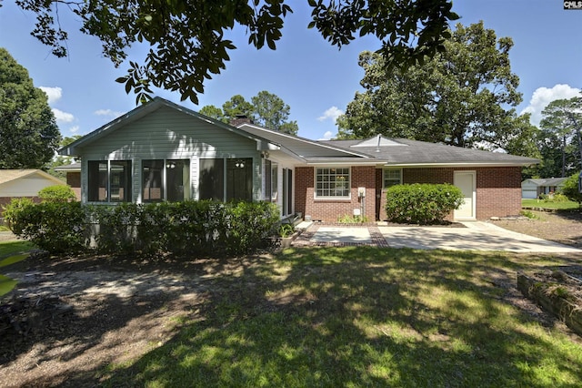 136 Traylors Gate Cir, Irmo, SC 29063 - ranch-style house with brick siding, a front yard, a chimney, and a patio area