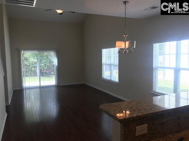 532 Slices Way, Chapin, SC 29036 - unfurnished dining area featuring healthy amount of natural light, dark wood-style flooring, a chandelier, and a ceiling fan