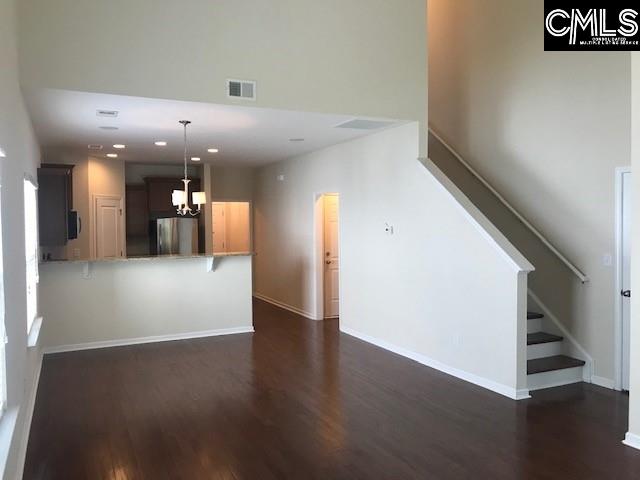 532 Slices Way, Chapin, SC 29036 - unfurnished living room with dark wood-type flooring, stairs, recessed lighting, and a chandelier