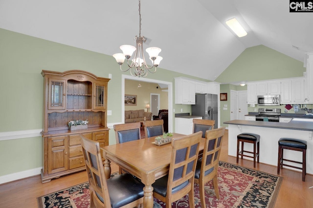 430 Plantation Pointe Dr, Elgin, SC 29045 - dining space featuring vaulted ceiling, a chandelier, and light wood-style flooring