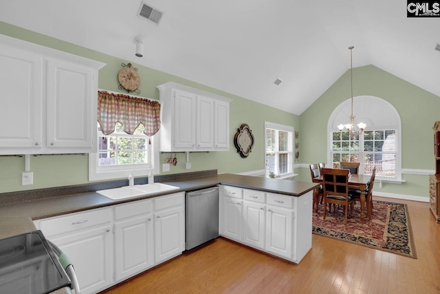 430 Plantation Pointe Dr, Elgin, SC 29045 - kitchen with stainless steel dishwasher, black range with electric stovetop, a peninsula, dark countertops, and lofted ceiling