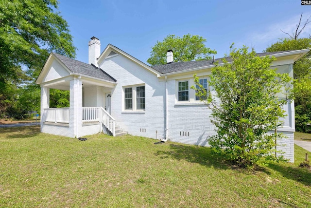 2500 Waites Rd, Columbia, SC 29204 - view of front of property featuring covered porch, brick siding, a front lawn, and a chimney