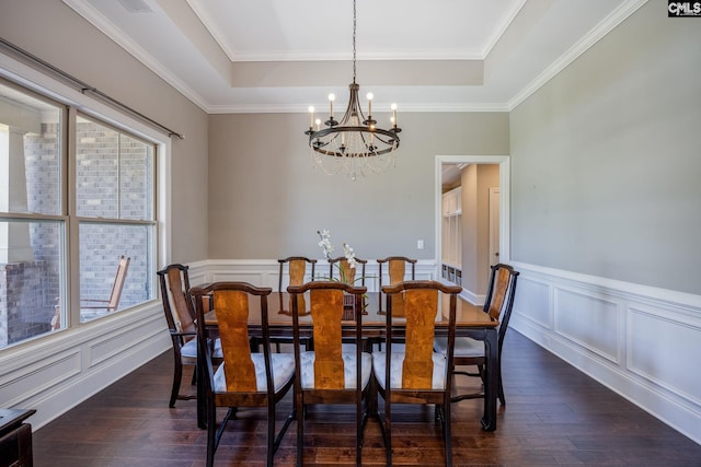 605 Flycatcher Ln, Blythewood, SC 29016 - dining room featuring a chandelier, a tray ceiling, dark wood-style floors, crown molding, and a wainscoted wall