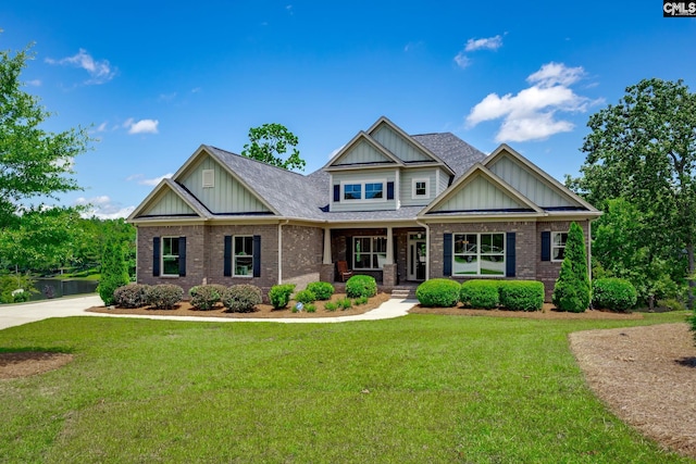 605 Flycatcher Ln, Blythewood, SC 29016 - craftsman-style home with board and batten siding, a porch, brick siding, and a front yard