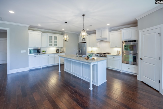605 Flycatcher Ln, Blythewood, SC 29016 - kitchen with appliances with stainless steel finishes, a kitchen island with sink, white cabinets, crown molding, and recessed lighting