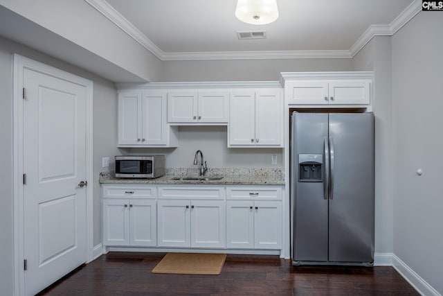 605 Flycatcher Ln, Blythewood, SC 29016 - kitchen with stainless steel appliances, ornamental molding, white cabinets, light stone countertops, and dark wood-type flooring