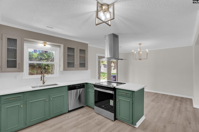 898 Perry Blvd, Sumter, SC 29154 - kitchen with appliances with stainless steel finishes, island exhaust hood, green cabinets, a peninsula, and light wood-style flooring