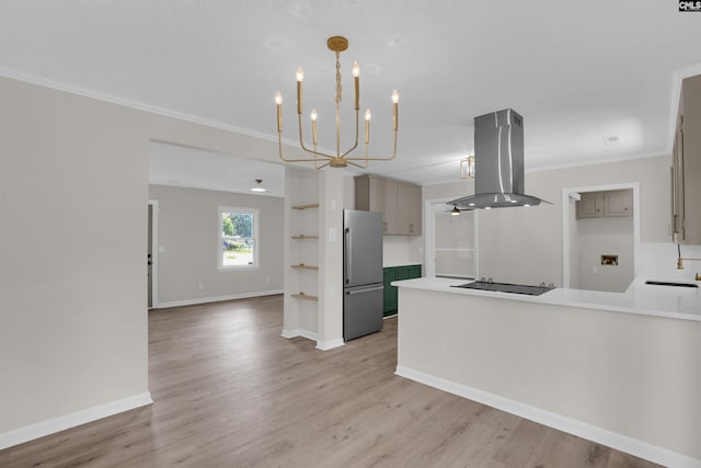 898 Perry Blvd, Sumter, SC 29154 - kitchen with island exhaust hood, freestanding refrigerator, crown molding, black electric cooktop, and light countertops