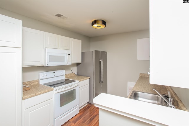 141 Wigmore Ln, Lexington, SC 29072 - kitchen with white appliances, white cabinets, wood finished floors, and light countertops