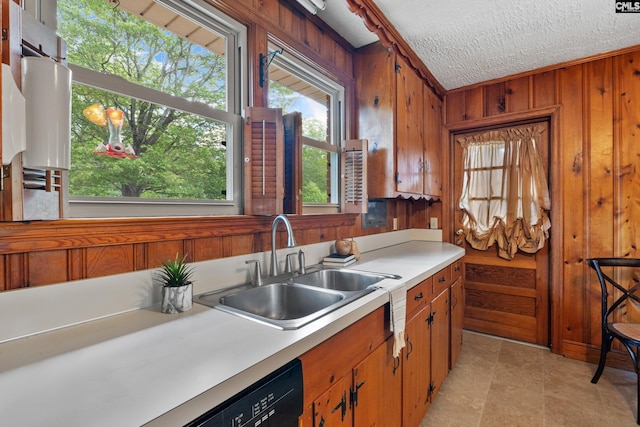 623 Hook Ave, West Columbia, SC 29169 - kitchen with light countertops, wooden walls, brown cabinets, a textured ceiling, and dishwashing machine