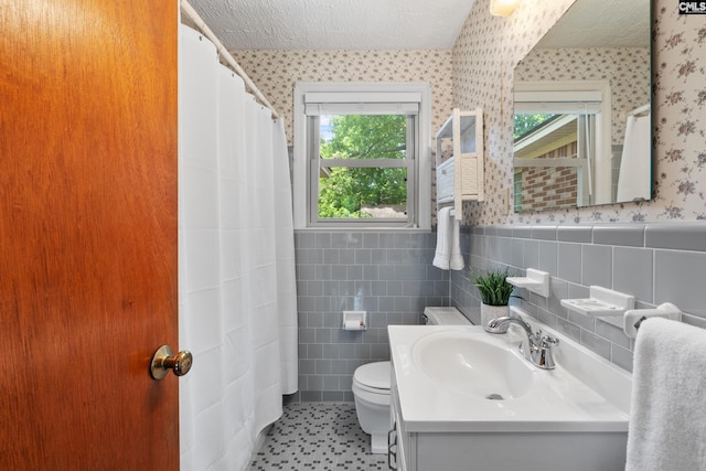 623 Hook Ave, West Columbia, SC 29169 - full bathroom with wallpapered walls, a wainscoted wall, vanity, tile walls, and curtained shower