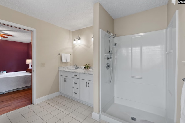 623 Hook Ave, West Columbia, SC 29169 - bathroom featuring a textured ceiling, double vanity, a shower, tile patterned floors, and ensuite bathroom