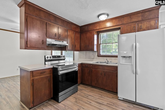 2017 Wellington Rd, Cayce, SC 29033 - kitchen featuring white refrigerator with ice dispenser, electric stove, under cabinet range hood, light countertops, and light wood finished floors
