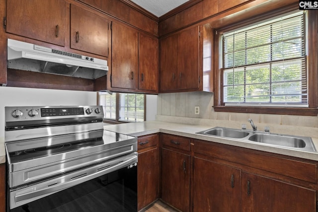 2017 Wellington Rd, Cayce, SC 29033 - kitchen featuring electric stove, under cabinet range hood, light countertops, and ornamental molding