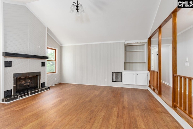 800 Valhalla Dr, Columbia, SC 29229 - unfurnished living room featuring lofted ceiling, wood finished floors, a tile fireplace, and a chandelier