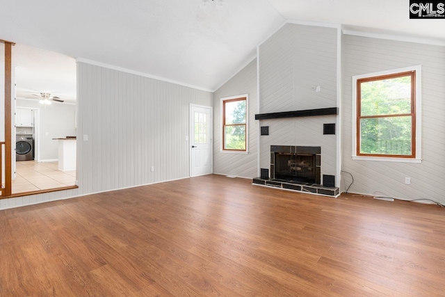 800 Valhalla Dr, Columbia, SC 29229 - unfurnished living room featuring washer / clothes dryer, lofted ceiling, a fireplace, wood finished floors, and ornamental molding