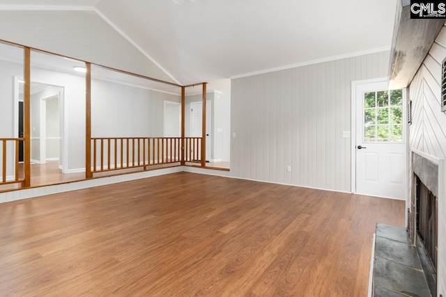 800 Valhalla Dr, Columbia, SC 29229 - unfurnished living room featuring wood finished floors, a fireplace with raised hearth, and vaulted ceiling