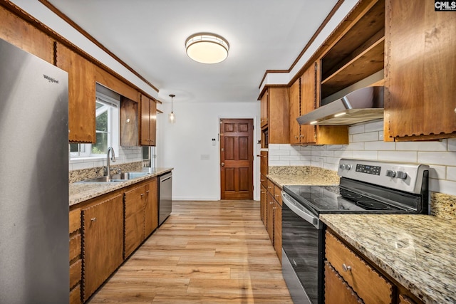 32 Nob Hill Rd, Columbia, SC 29210 - kitchen with appliances with stainless steel finishes, wall chimney range hood, brown cabinets, tasteful backsplash, and light wood-style floors