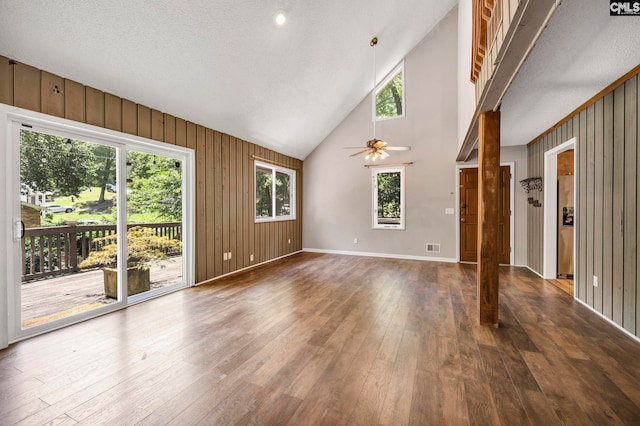 32 Nob Hill Rd, Columbia, SC 29210 - unfurnished living room featuring dark wood-type flooring, high vaulted ceiling, ceiling fan, and wood walls