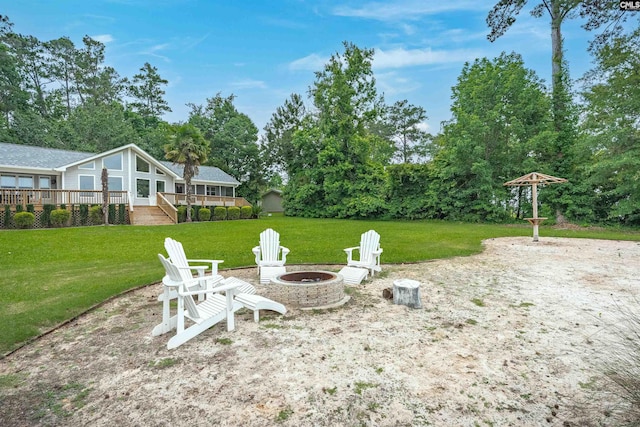 116 Laurel Rock Pt, Leesville, SC 29070 - view of grassy yard with a fire pit, a wooden deck, and view of wooded area