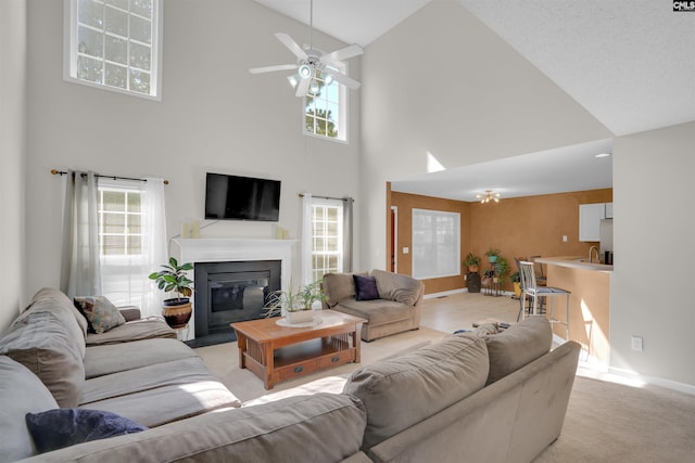 316 Founders Ridge Rd, Columbia, SC 29229 - living room featuring high vaulted ceiling, light colored carpet, a glass covered fireplace, and ceiling fan