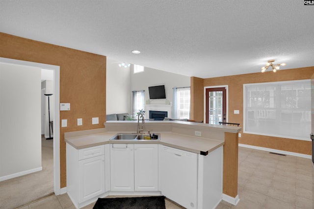 316 Founders Ridge Rd, Columbia, SC 29229 - kitchen with dishwasher, open floor plan, a fireplace, a peninsula, and white cabinetry