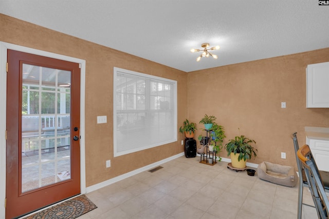 316 Founders Ridge Rd, Columbia, SC 29229 - doorway with a chandelier and a textured ceiling