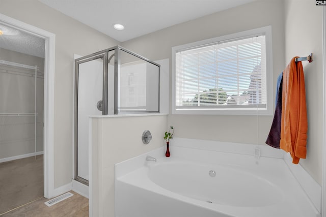 316 Founders Ridge Rd, Columbia, SC 29229 - bathroom featuring a bath, a stall shower, and a spacious closet