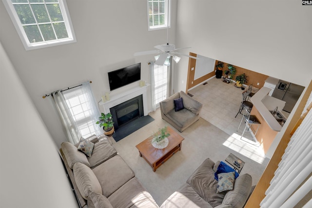 316 Founders Ridge Rd, Columbia, SC 29229 - living area featuring healthy amount of natural light, a towering ceiling, a fireplace with flush hearth, and a ceiling fan