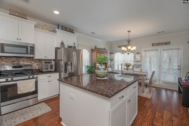 532 Ariel Cir, Lexington, SC 29072 - kitchen featuring appliances with stainless steel finishes, a chandelier, dark wood-style flooring, backsplash, and a kitchen island