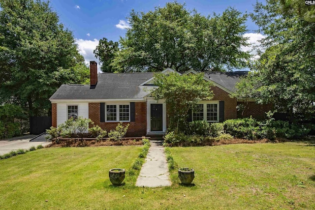 1005 D Ave, West Columbia, SC 29169 - view of front facade featuring a front lawn, a chimney, and brick siding