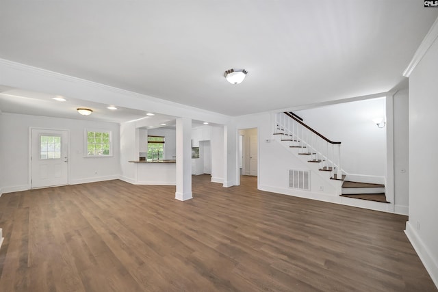 1005 D Ave, West Columbia, SC 29169 - unfurnished living room with stairs, dark wood-type flooring, and crown molding