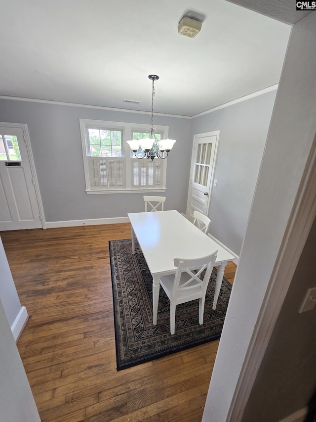 1001 Maple, Columbia, SC 29205 - dining space with crown molding, a chandelier, and wood finished floors