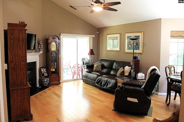 499 Woodhouse Loop, Irmo, SC 29063 - living area featuring a ceiling fan, light wood-style flooring, vaulted ceiling, and a fireplace with flush hearth