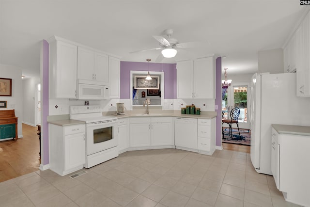 1176 Whippoorwill Rd, Prosperity, SC 29127 - kitchen featuring white appliances, ceiling fan, white cabinetry, light countertops, and a chandelier