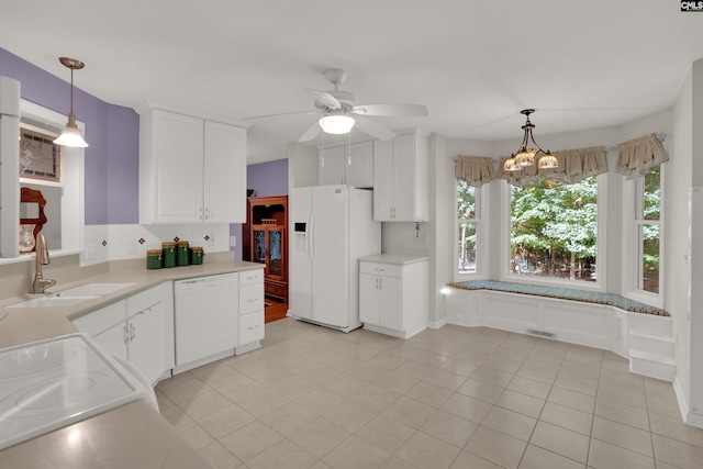 1176 Whippoorwill Rd, Prosperity, SC 29127 - kitchen featuring white appliances, light countertops, white cabinets, and pendant lighting