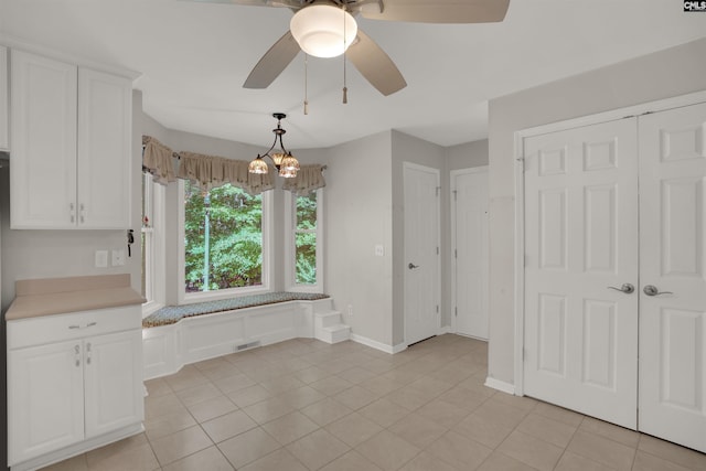 1176 Whippoorwill Rd, Prosperity, SC 29127 - unfurnished dining area featuring ceiling fan, light tile patterned floors, and a chandelier