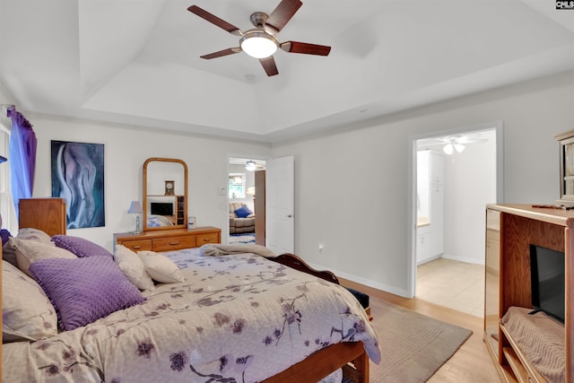 1176 Whippoorwill Rd, Prosperity, SC 29127 - bedroom with a tray ceiling, light wood-style flooring, ensuite bathroom, and ceiling fan