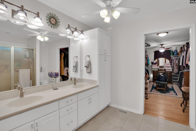 1176 Whippoorwill Rd, Prosperity, SC 29127 - full bathroom featuring a ceiling fan, a spacious closet, tile patterned flooring, double vanity, and a stall shower