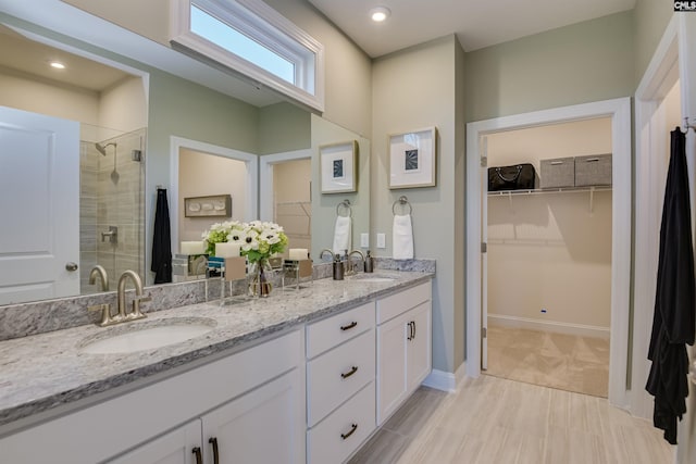 821 Oak Valley Dr, Blythewood, SC 29016 - bathroom with double vanity, a stall shower, a walk in closet, and recessed lighting