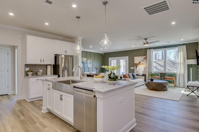 821 Oak Valley Dr, Blythewood, SC 29016 - kitchen featuring stainless steel appliances, crown molding, a kitchen island with sink, light wood-style flooring, and recessed lighting