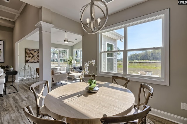 793 Oak Valley Dr, Blythewood, SC 29016 - dining area with wood finished floors, a chandelier, a ceiling fan, vaulted ceiling, and decorative columns