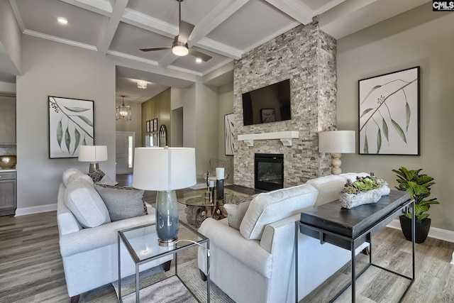 793 Oak Valley Dr, Blythewood, SC 29016 - living room featuring wood finished floors, beamed ceiling, a ceiling fan, coffered ceiling, and a stone fireplace