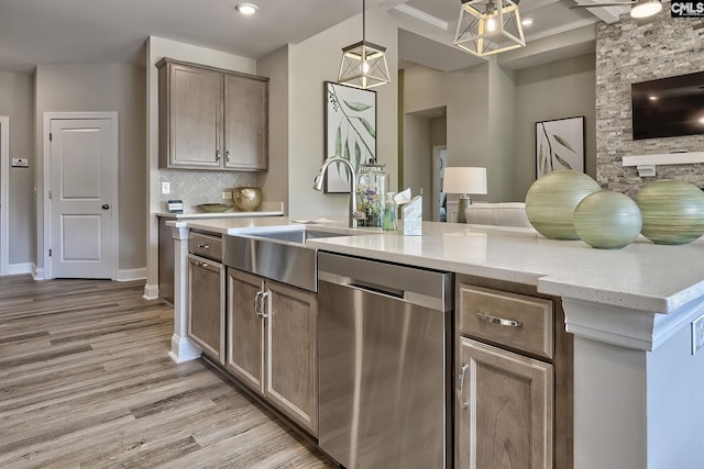 793 Oak Valley Dr, Blythewood, SC 29016 - kitchen featuring dishwasher, light wood finished floors, decorative light fixtures, backsplash, and light stone countertops