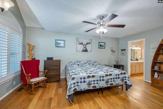 111 Double Branch Ct, West Columbia, SC 29169 - bedroom with light wood-style floors, a textured ceiling, ensuite bathroom, and a ceiling fan