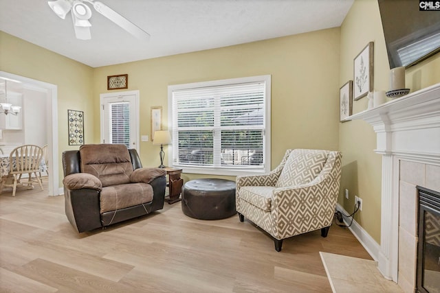 113 Chalfont Ln, Columbia, SC 29229 - living area with light wood finished floors, a tiled fireplace, ceiling fan, and a chandelier