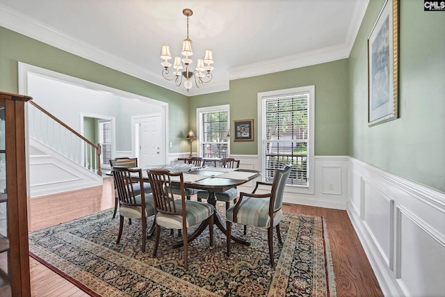 113 Chalfont Ln, Columbia, SC 29229 - dining area featuring a chandelier, wood finished floors, ornamental molding, a wainscoted wall, and stairway