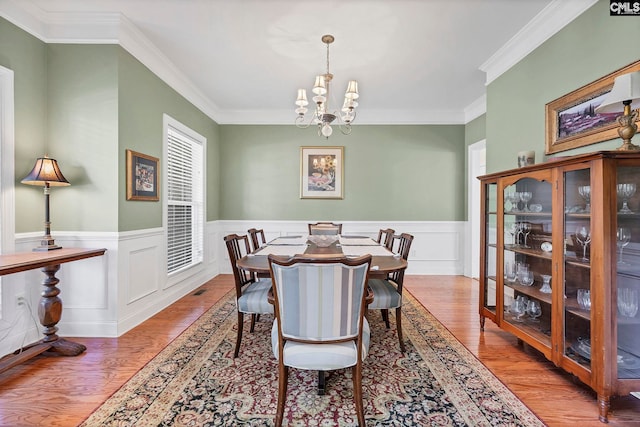 113 Chalfont Ln, Columbia, SC 29229 - dining space with a chandelier, wood finished floors, ornamental molding, and wainscoting
