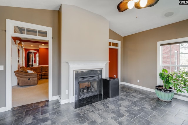 340 Heritage Forest Dr, Blythewood, SC 29045 - living area featuring vaulted ceiling, a ceiling fan, dark stone finish flooring, and a fireplace