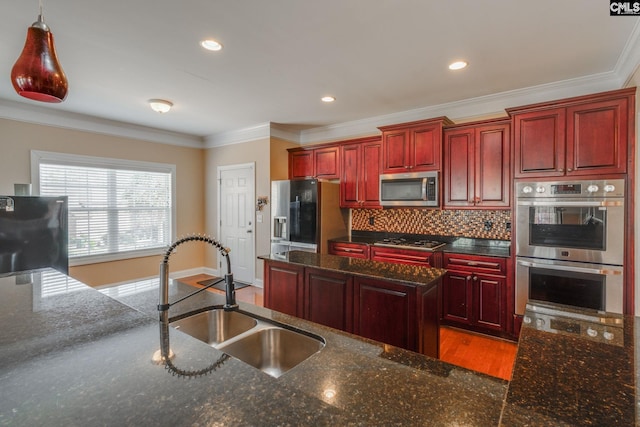 340 Heritage Forest Dr, Blythewood, SC 29045 - kitchen with stainless steel appliances, reddish brown cabinets, ornamental molding, decorative backsplash, and dark stone counters
